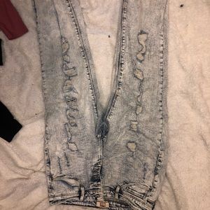 Acid washed ripped jeans with patches